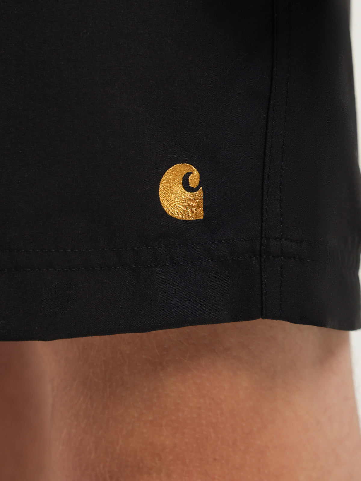 Carhartt Wip Chase Swim Trunks in Black & Gold | Black/Gold