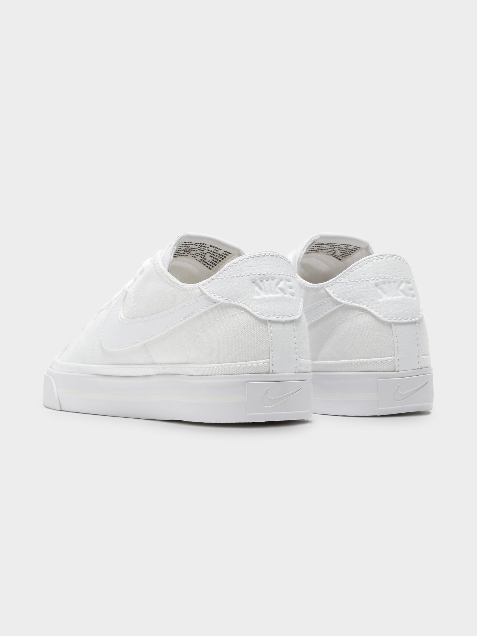 Nike white hotsell canvas sneakers womens